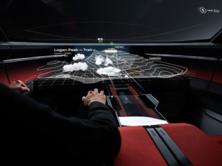 Driver at wheel of Audi activesphere concept car with topographic projection