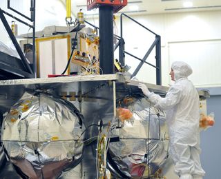 Technician inspects Juno's vault – a titanium box that will enclose key spacecraft components, shielding them from Jupiter's intense radiation fields.