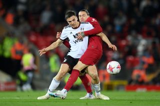 Fulham's Joao Palhinha tussling with Liverpool's Darwin Nunez