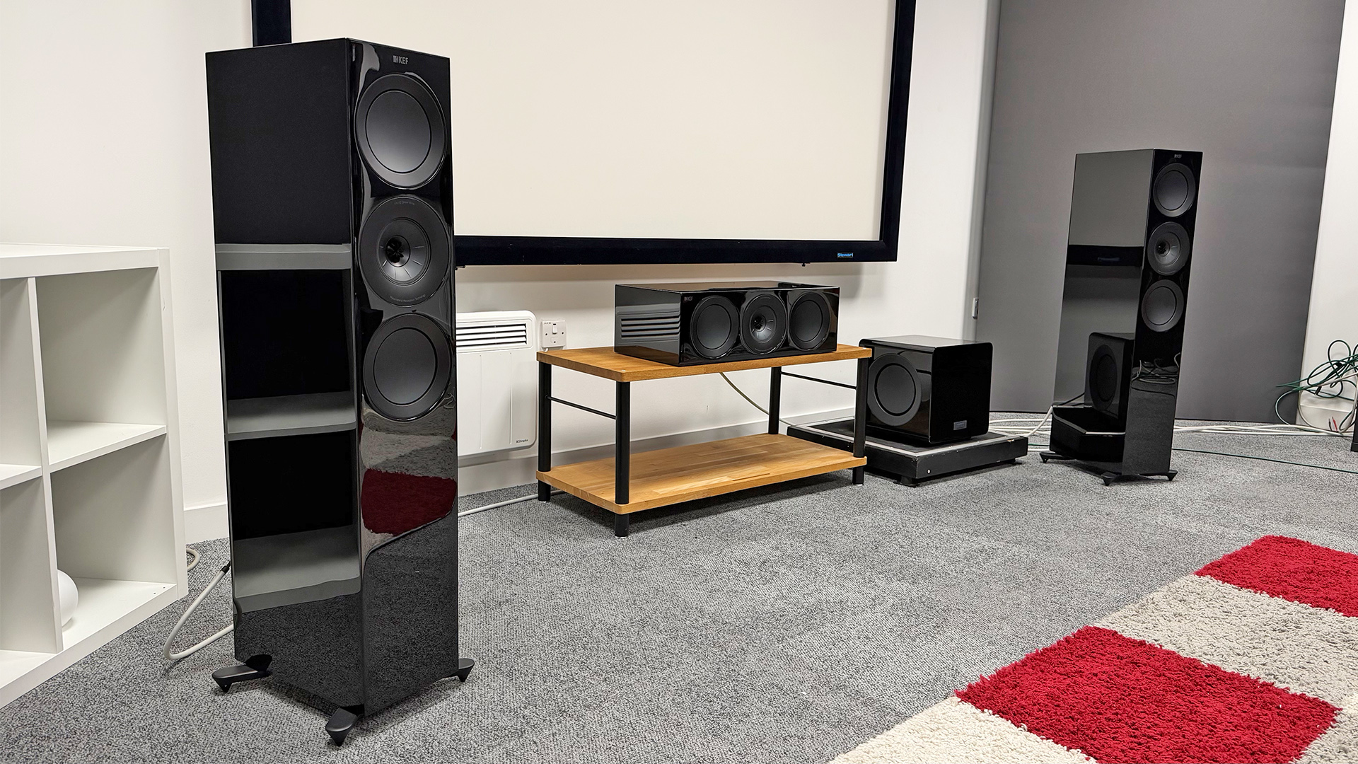 KEF R Meta 5.1 Speaker System speaker package floorstanding, centre and sub speakers in grey carpeted test room