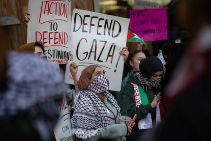 Students from Hunter College chant and hold up signs during a pro-Palestinian demonstration