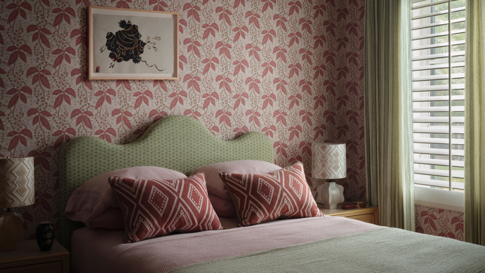 Girl&amp;rsquo;s bedroom with pink botanical wallpaper, scalloped green headboard, patterned cushions and pale green curtains.