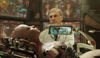 Alita: Battle Angel Christoph Waltz looks over the recovered Alita on the operating table