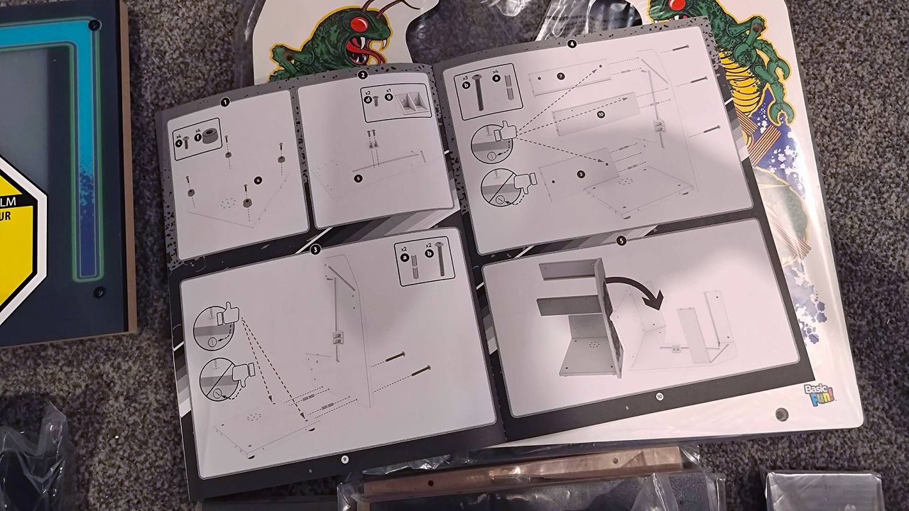 Arcade Classics Centipede instructions open on floor on top of parts.