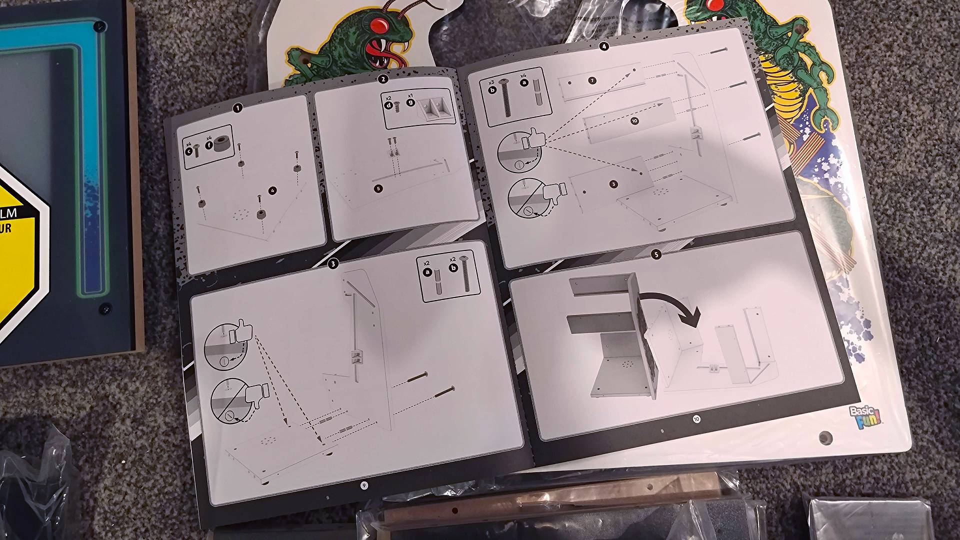 Arcade Classics Centipede instructions open on floor on top of parts.