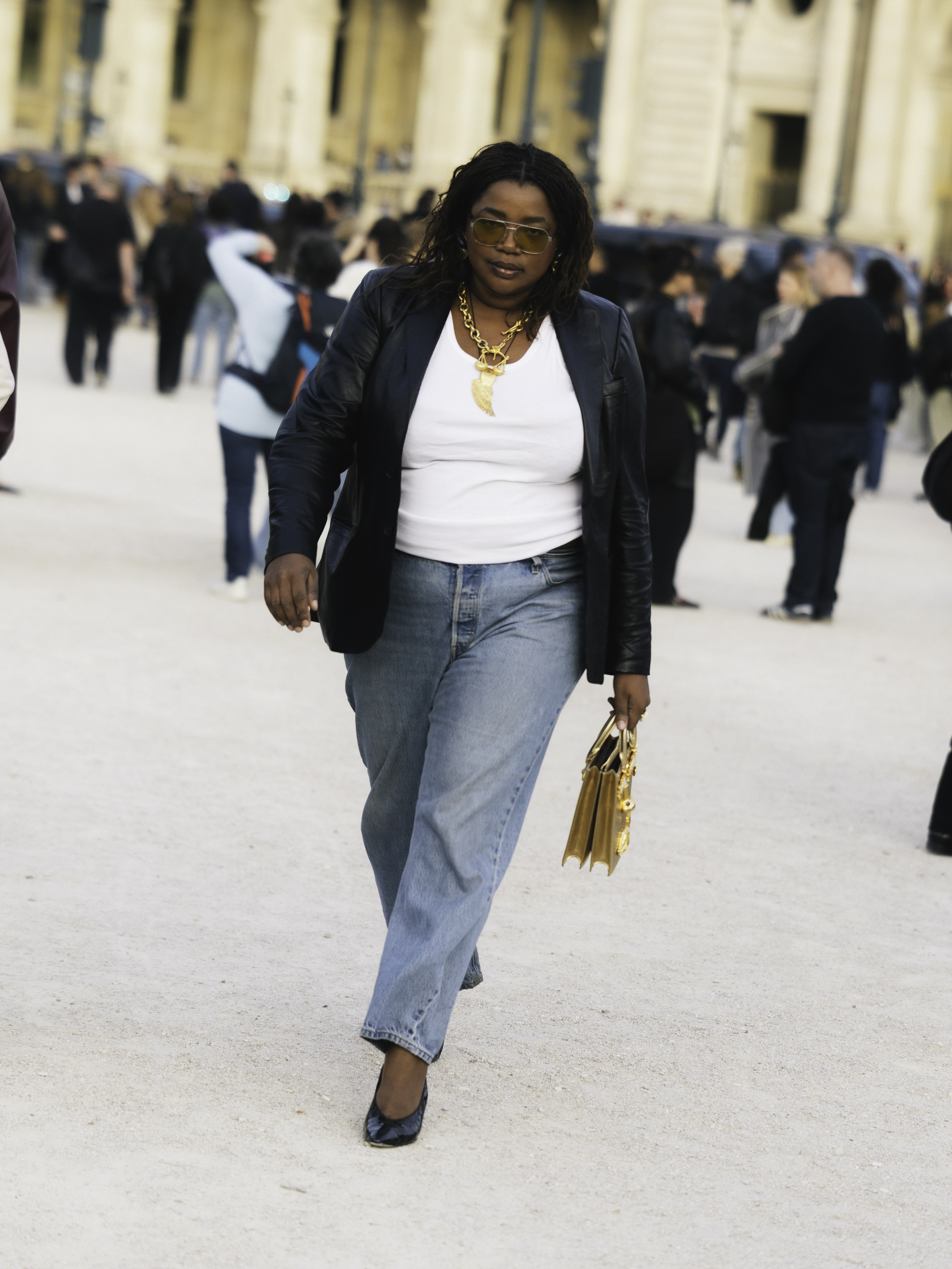 Gabriella Karefa Johnson wearing a blazer, a white top, jeans, and heels