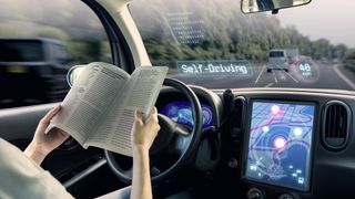 A woman reading a book in the driver's seat while the car drives itself