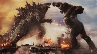 Scene from Godzilla vs. Kong (2021). Here we Godzilla (giant lizard monster) and King Kong (giant ape) fighting each other whilst standing on an air craft carrier battleship.