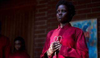 Us Lupita Nyong'o holds her scissors solemnly