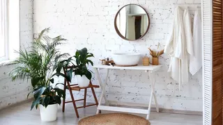 White bathroom with painted brick wall