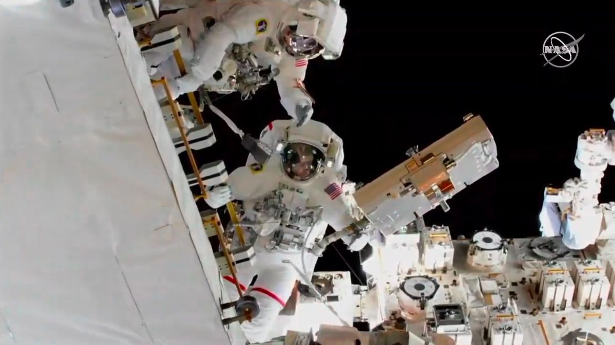 NASA astronauts Nick Hague (left) and Anne McClain work to install adapter plates on new lithium-ion batteries during a spacewalk on March 22, 2019. 