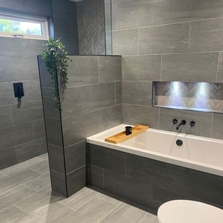 grey bathroom with black taps