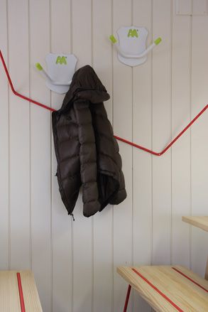 coat hung from the deer-horn-trophy hooks