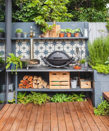 An outdoor kitchen with a grill and star tiled background