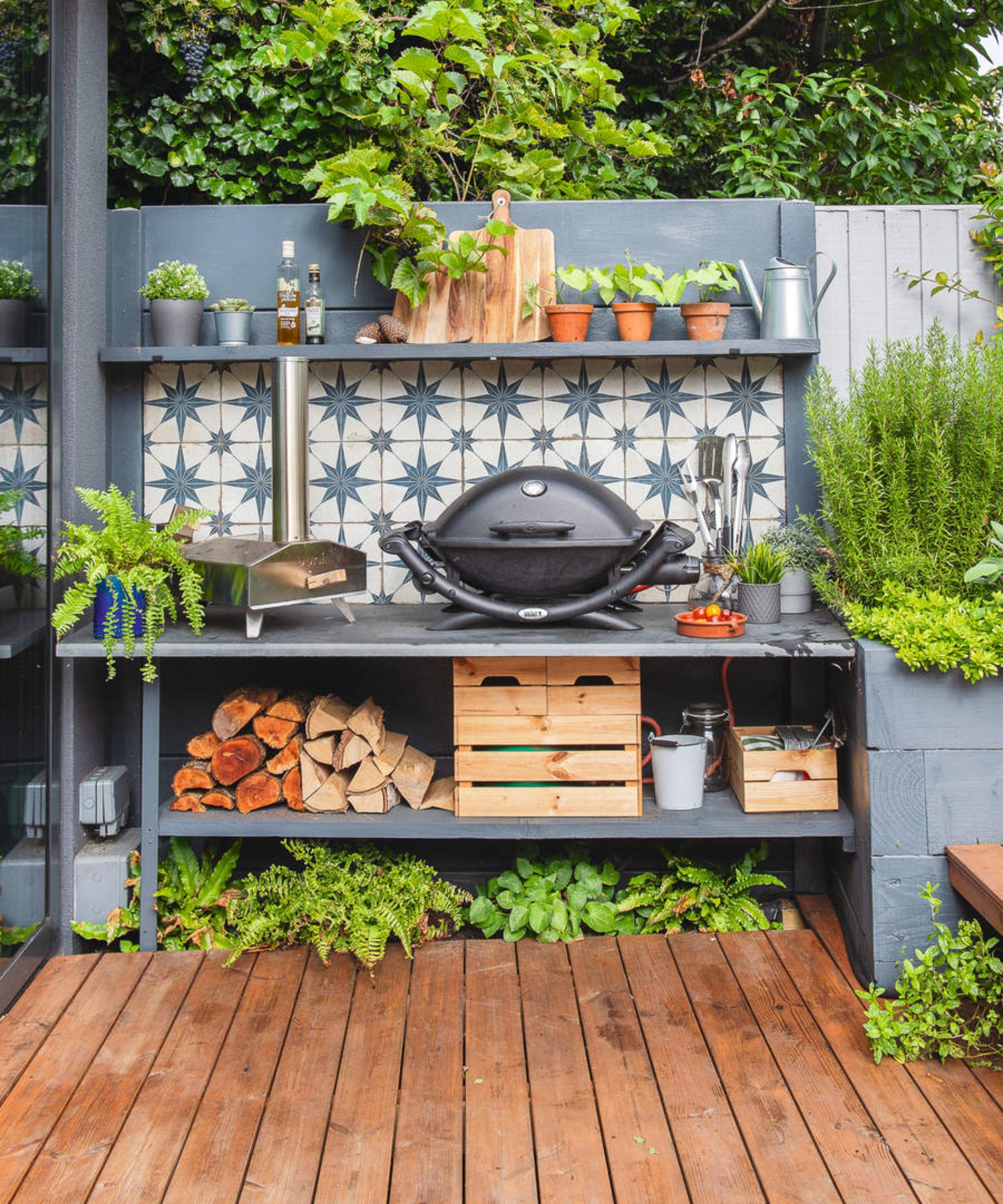 An outdoor kitchen with a grill and star tiled background