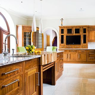 kitchen area with ceramic worktop and white tiles floor and white wall