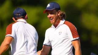Rory McIlroy of Team Europe high fives Tommy Fleetwood of Team Europe on the 15th hole during the Ryder Cup at Marco Simone Golf & Country Club on Saturday, September 30, 2023 in Rome, Italy.