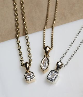 Three chunky charms on necklaces