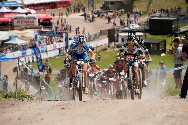 Pro Women drag race up the dirt road climb before entering singletrack.