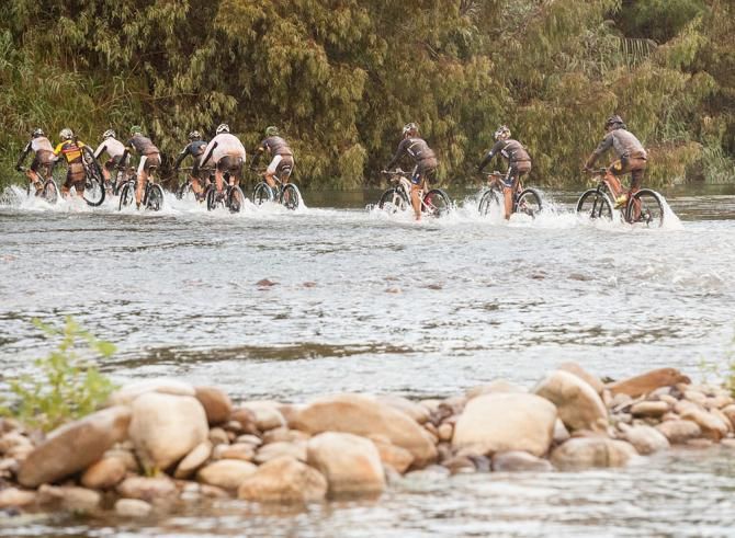 Riders go through a stream crossing