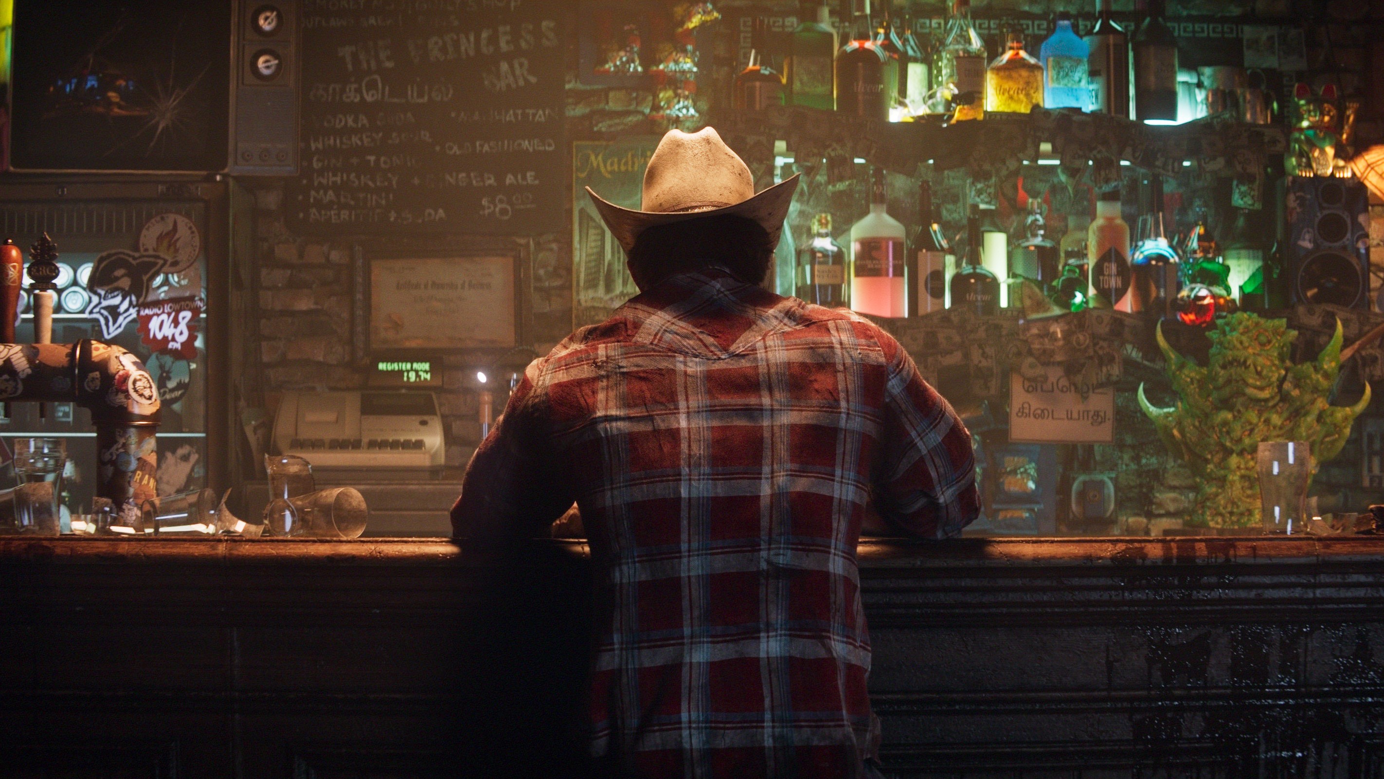 Wolverine sitting in a bar, his back is facing the screen