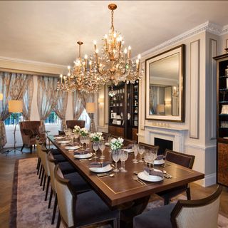 dining room with big dining table and chandelier