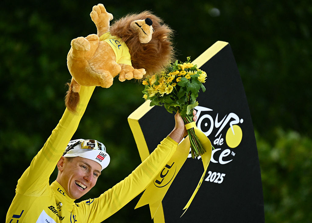 UAE Team Emirates - XRG team&#039;s Slovenian rider Tadej Pogacar celebrates on the podium with the overall leader&#039;s yellow jersey after the 21st and final stage of the 112th edition of the Tour de France cycling race, 132.3 km between Mantes-la-Ville and Paris Champs-Ã‰lysees, on July 27, 2025. (Photo by Loic VENANCE / AFP)