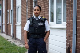 PC Lizzie Adama wearing a bracelet and posing in her police uniform.