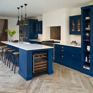 kitchen with white wall and blue cabinets with white countertop