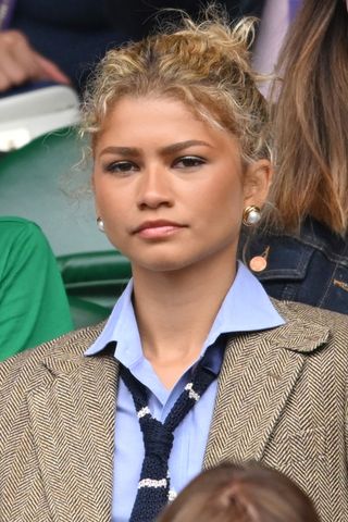 Zendaya is pictured with a curly updo at day thirteen of the Wimbledon Tennis Championships at the All England Lawn Tennis and Croquet Club on July 13, 2024 in London, England.