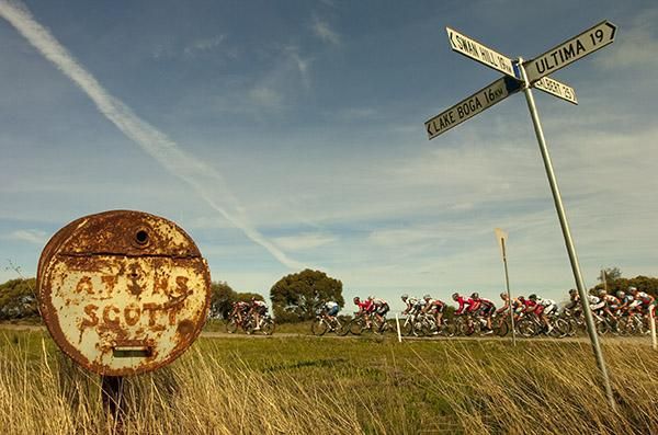 The peloton speed into the final kilometres approaching the finish in Lake Boga.