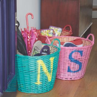 baskets in doorway with coloured baskets with initials full of shoes