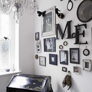 white office with walled pictures and chandelier