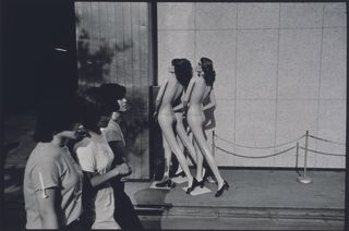 photo of people walking past undressed shop dummies