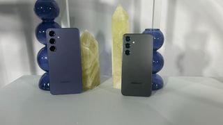 Samsung Galaxy S24 Plus in violet and S24 in grey with crystals in the background