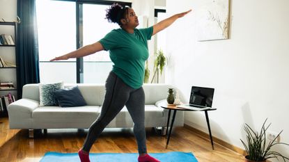 Woman doing workout at home on yoga mat