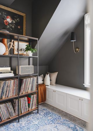 A storage unit in metal holding records, a speaker and books