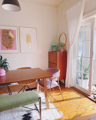 Dining table with chairs and open window