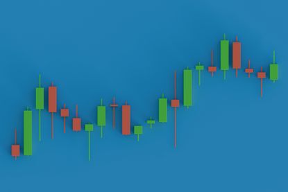 candlestick chart with green and red bars and wicks forming an upward pattern on a blue studio background.