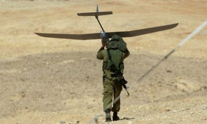 Drone technology has revolutionized warfare. An Israeli soldier is seen here carrying a drone during a military exercise.