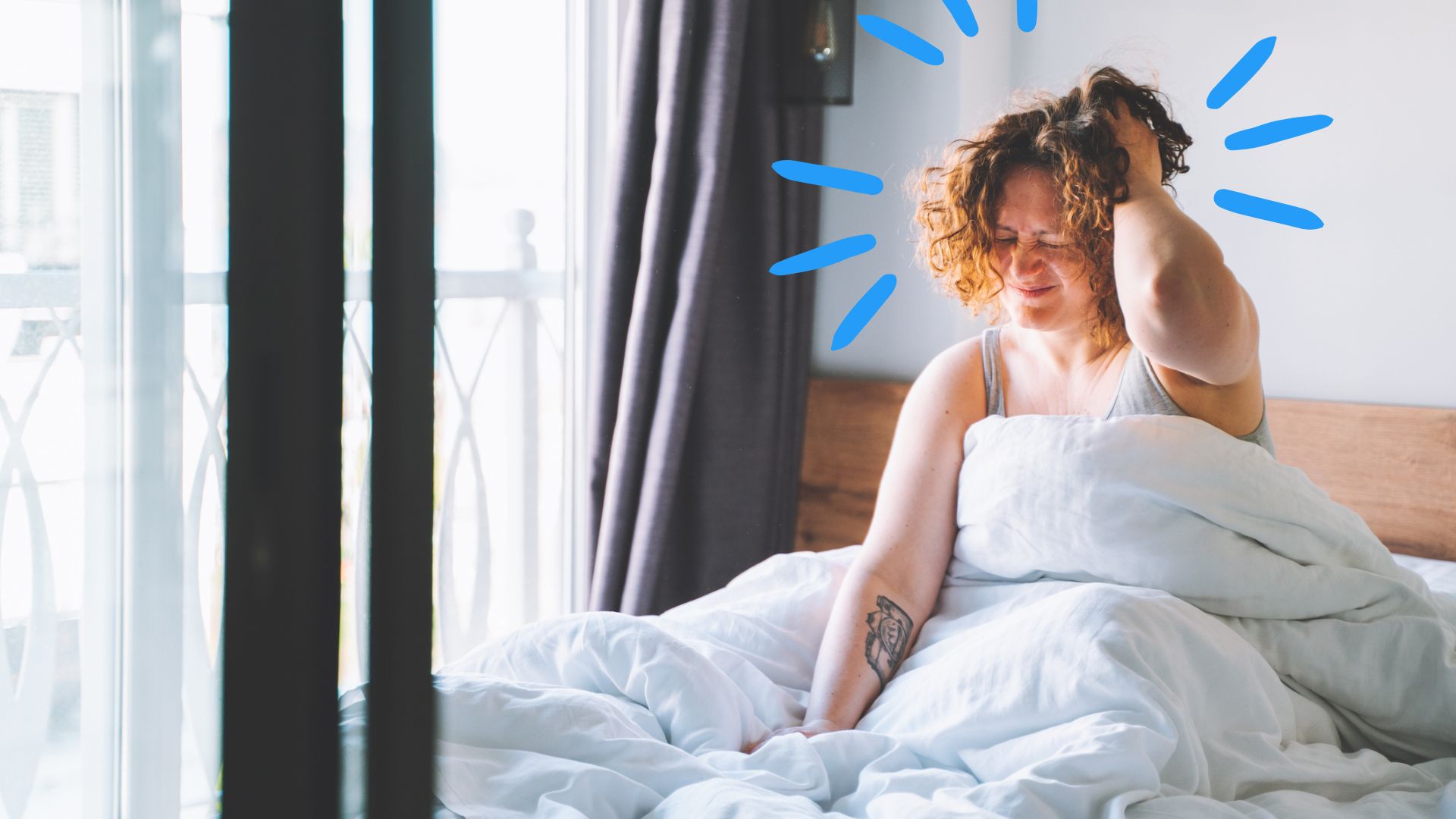 A woman waking up to exploding head syndrome, holding her head in frustration