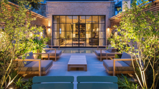 modern urban courtyard garden with lit trees