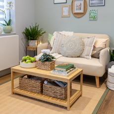 neutral living room with rattan rug, cream sofa and wooden coffee table