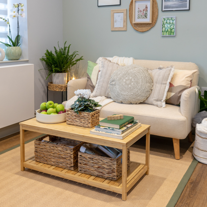 neutral living room with rattan rug, cream sofa and wooden coffee table