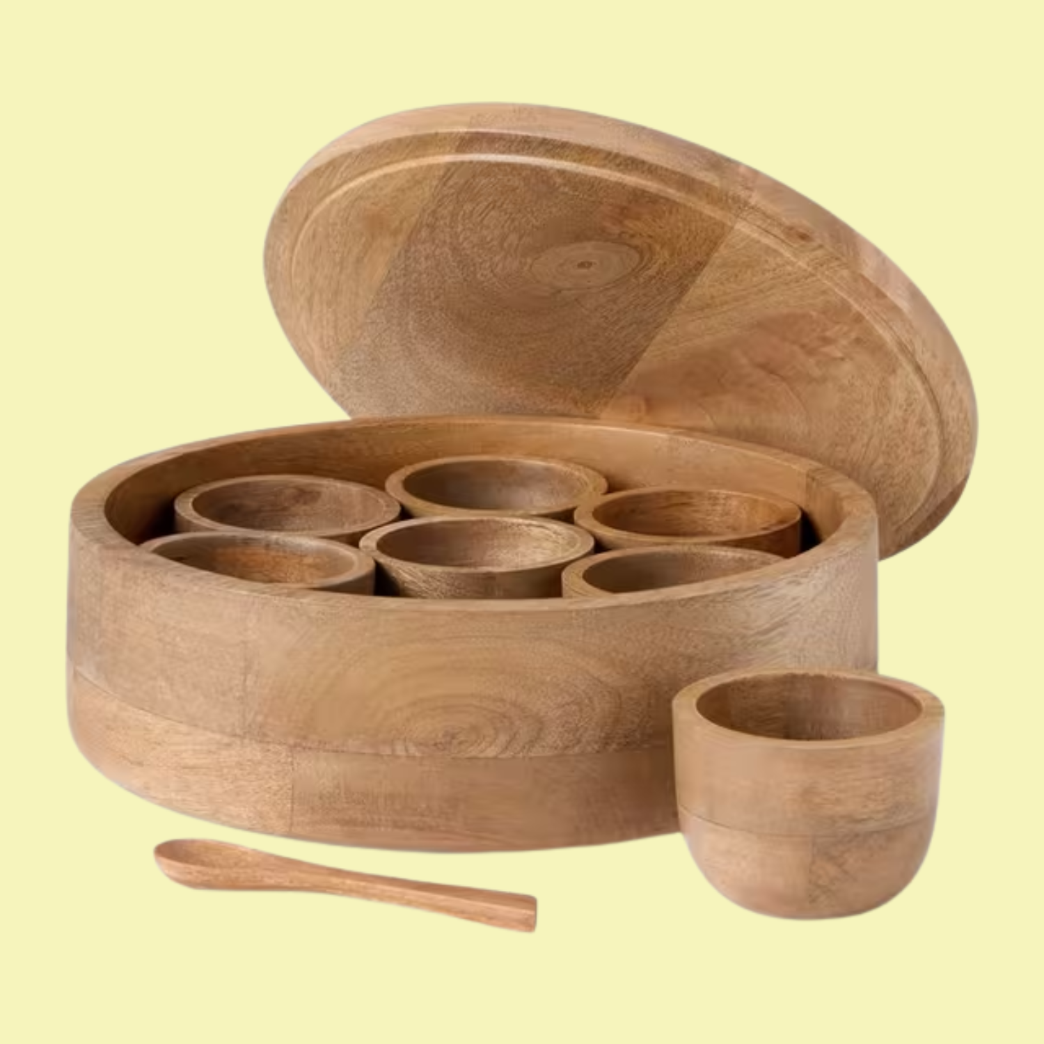 A mango wood circular masala dabba