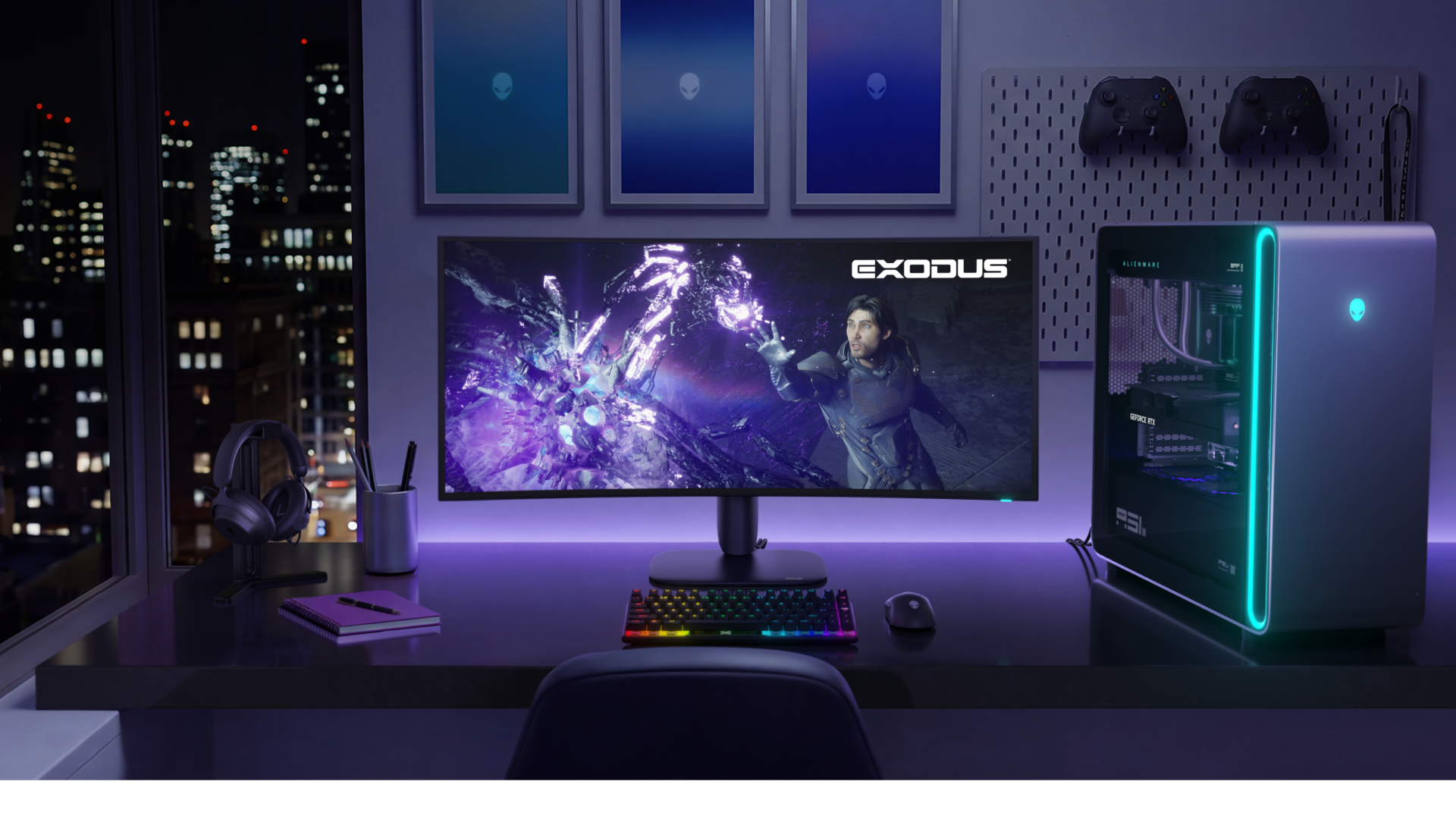 Front view of the Alienware 39 5K OLED gaming monitor (AW3926QW) on a dark gaming desk next to an Alienware Aurora PC tower in a sleek gaming setup