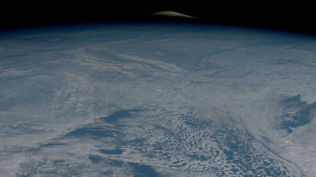 curve of moon seen above the planet earth