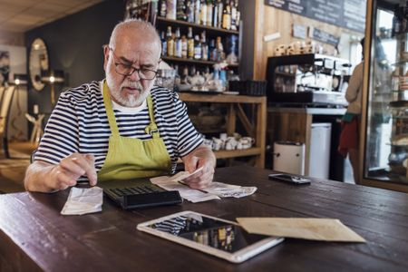 Business Owner Calculating His Finances