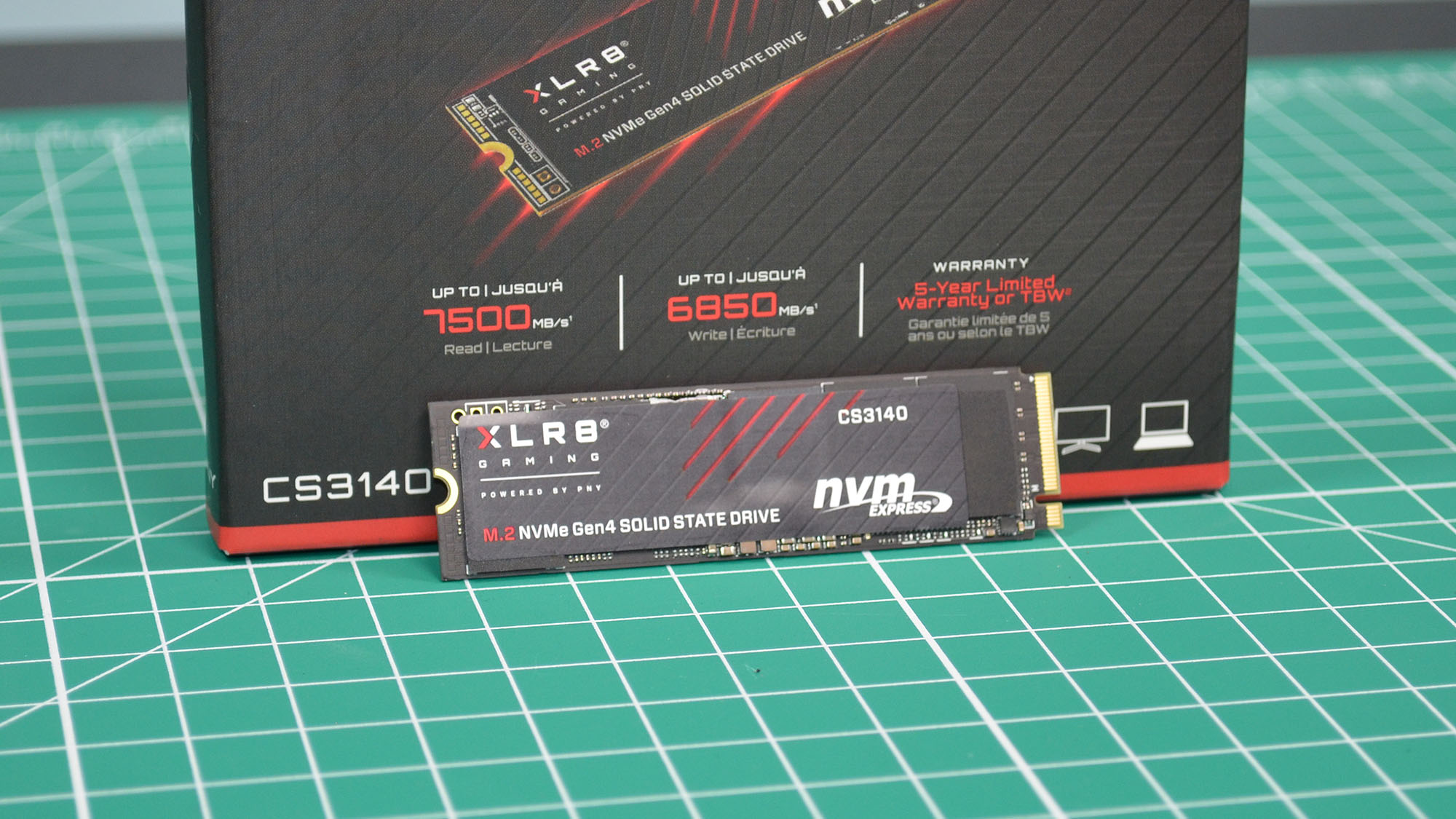 A PNY XLR8 CS3140 M.2 SSD on a desk with it's retail packaging