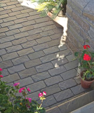 A grey block paving with offset style lines